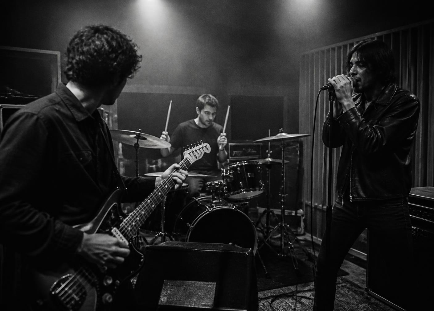 A band rehearsing together in a dedicated music studio